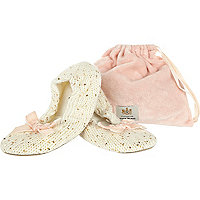 Cream sequin slippers in a bag