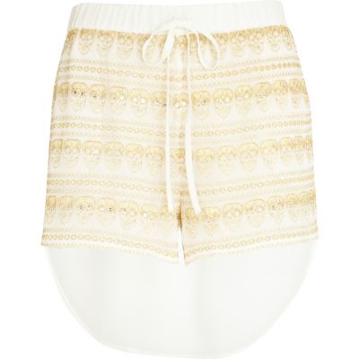 Cream skull lace diamante dip hem shorts