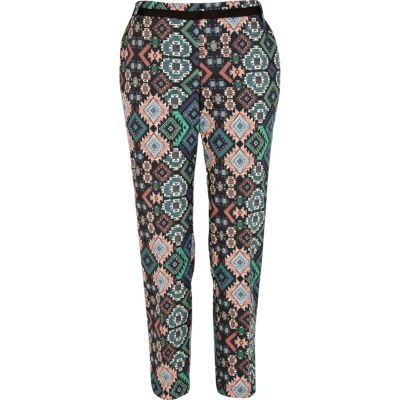 Orange Aztec print trousers