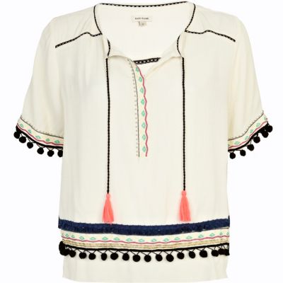 Cream pom pom embellished trim top