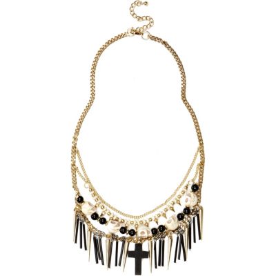 Gold tone skull and cross necklace