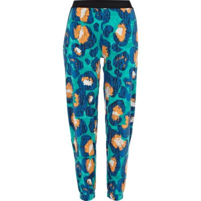 Green animal print jogger trousers