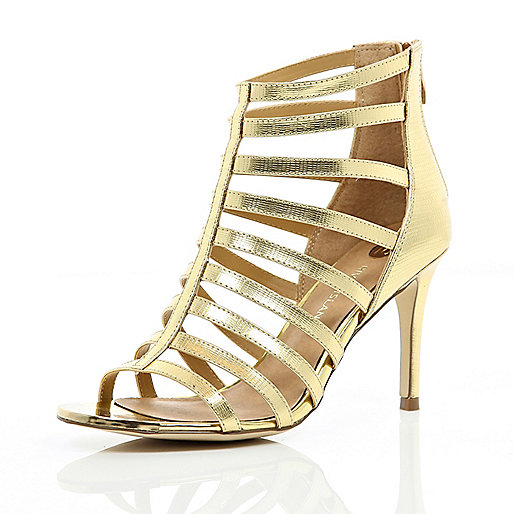 Strap out in these gold gladiator mid heel sandals. Featuring a zip ...
