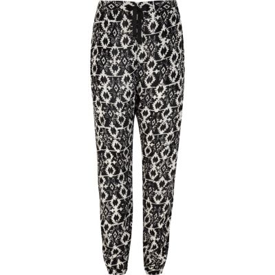 Girls black aztec print trousers