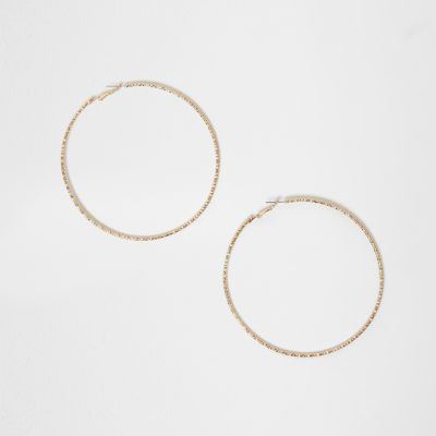 Gold tone faceted oversized hoop earrings