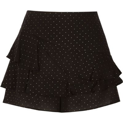 Zwarte en goudkleurige skort met stippen en ruches