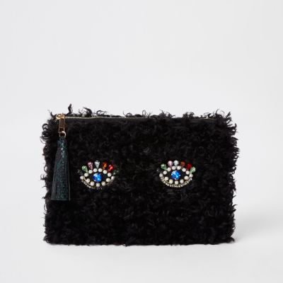Black borg embellished eye clutch bag